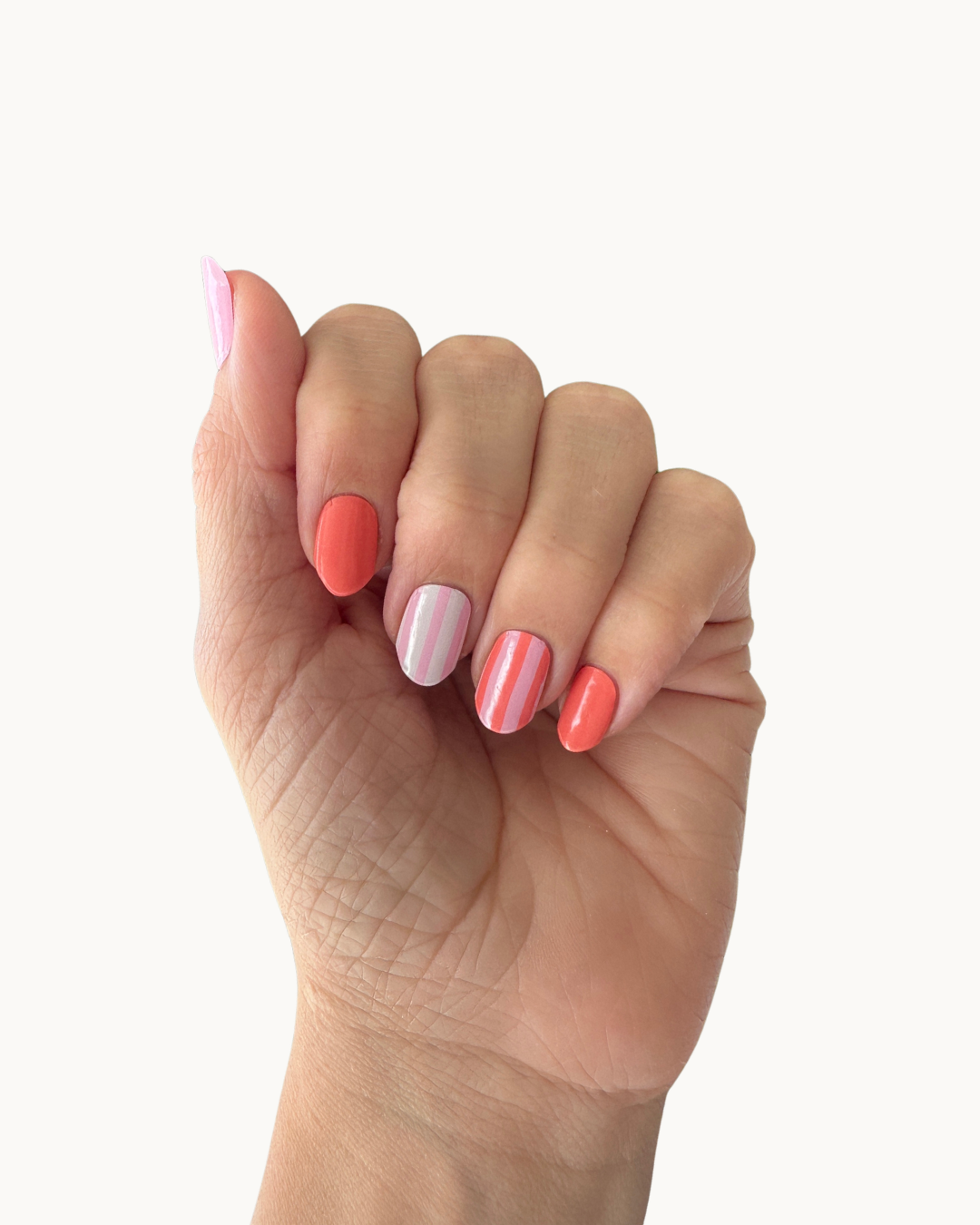 Coral Cabana gel nails shown on a hand