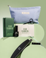 Mani starter kit contents — blue Ami Amour pouch with top coat, file, clippers and prep tools on sage green.